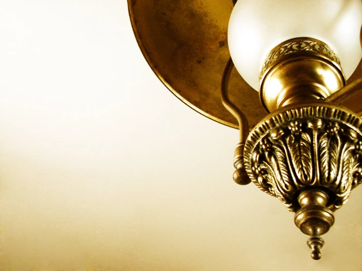 this is a gold lamp with its round glass bulb