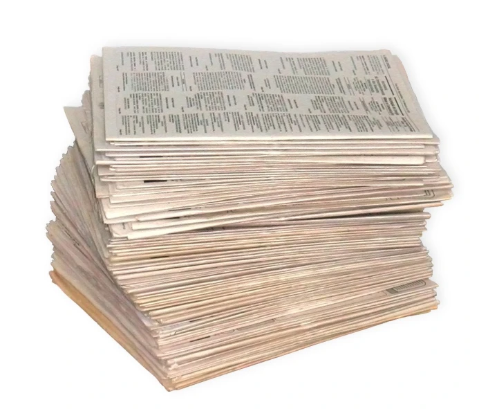 a stack of newspapers on a white surface