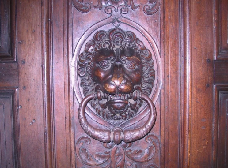 a carved wooden door with a decorative head