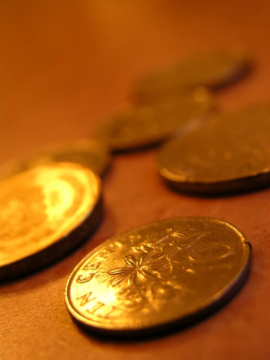 several gold coins that are sitting on a table