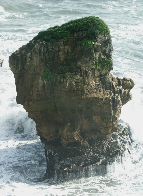 a rock that is sticking out of the water