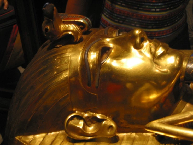 a gold head of an ancient egyptian or buddha sculpture