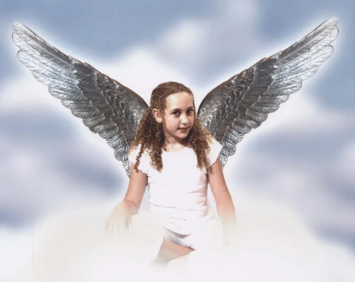 the angel is smiling, dressed in white, while sitting on clouds