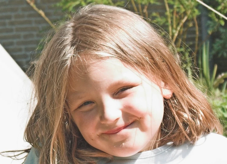 a little girl smiles in front of the camera