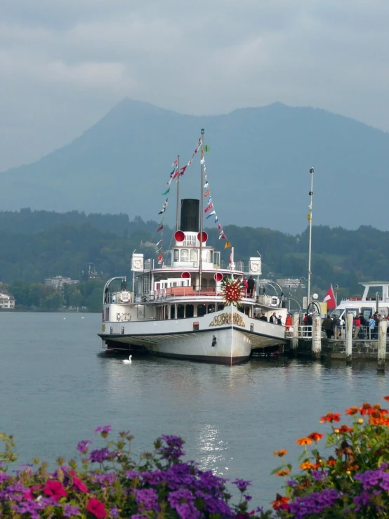 a boat is parked at the dock of a lake