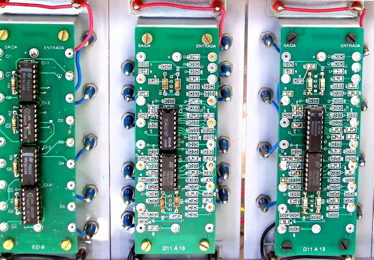 three electronic circuit boards in a white box