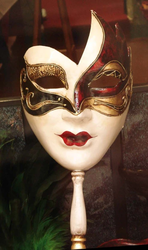 an ornate mask with red and gold stripes