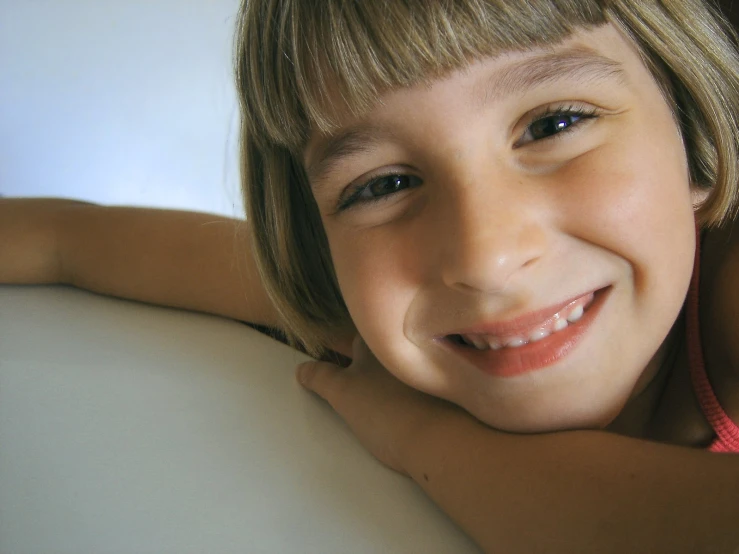 a little girl that is smiling at the camera