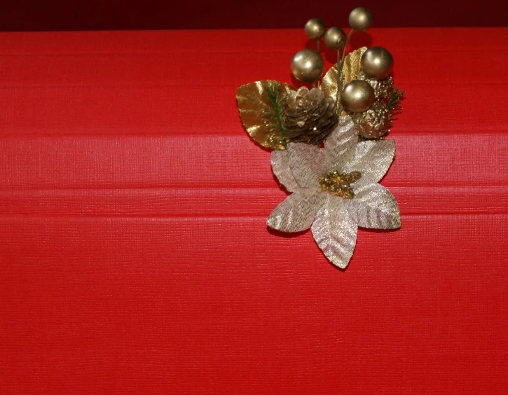 a red suitcase with decorations sitting on top of it