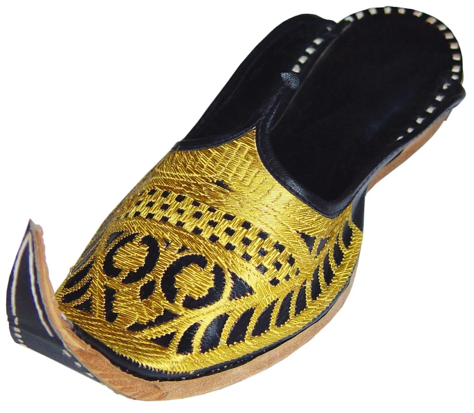 a pair of shoes that are decorated with gold and black design