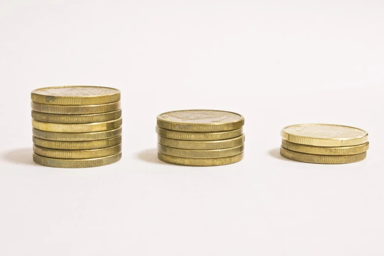 several gold coins are stacked on top of each other