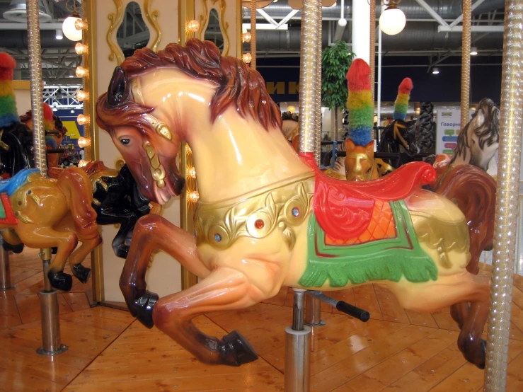 two horses in a carousel with carousel lights and decorations