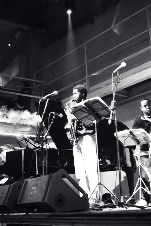 a band playing music on stage in an auditorium