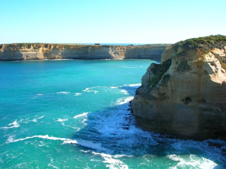 the blue waters and cliffs of the coastline