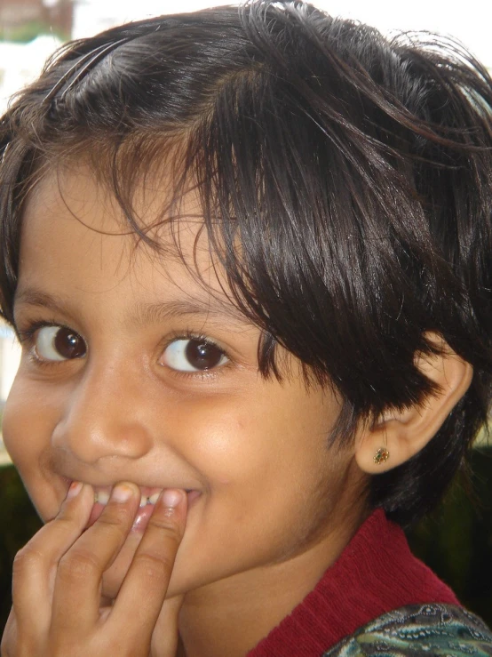 a young child who is putting his finger in its mouth