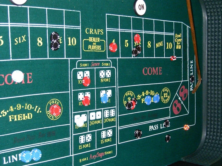a black casino game table with casino chips and dice