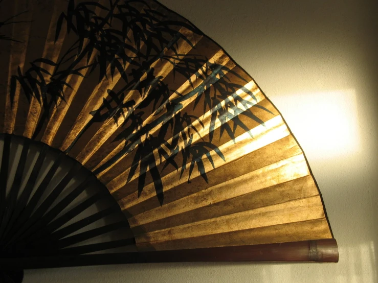 a bamboo fan with sun light coming through it