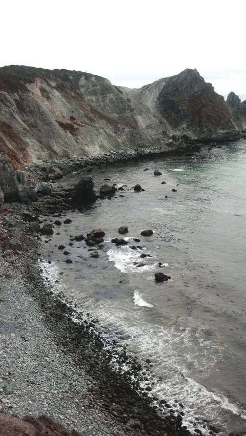 an empty beach is shown from above it