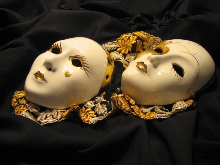 the white masks have gold beads all over them