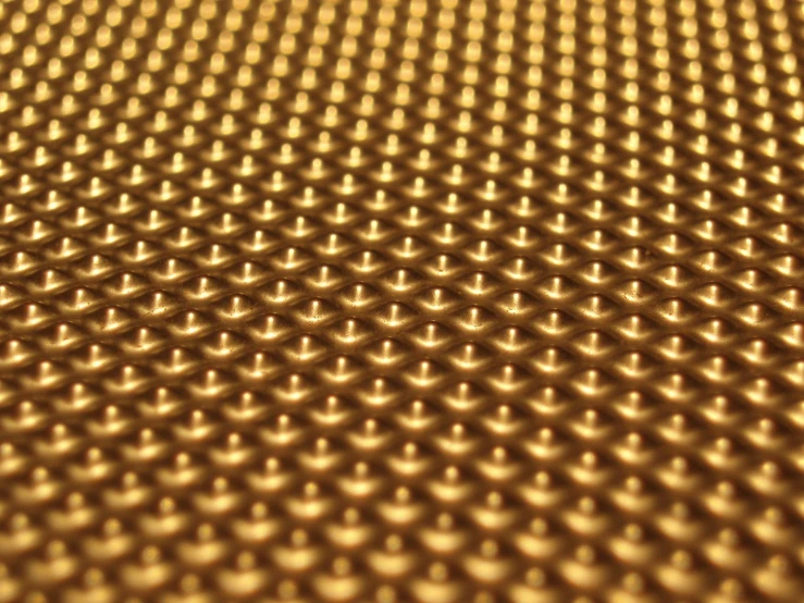 the pattern on the surface of a golden metal plate