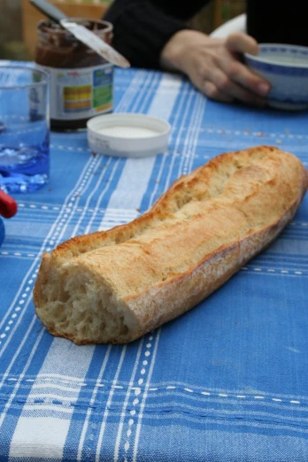 a loaf of bread sitting on top of a blue tablecloth