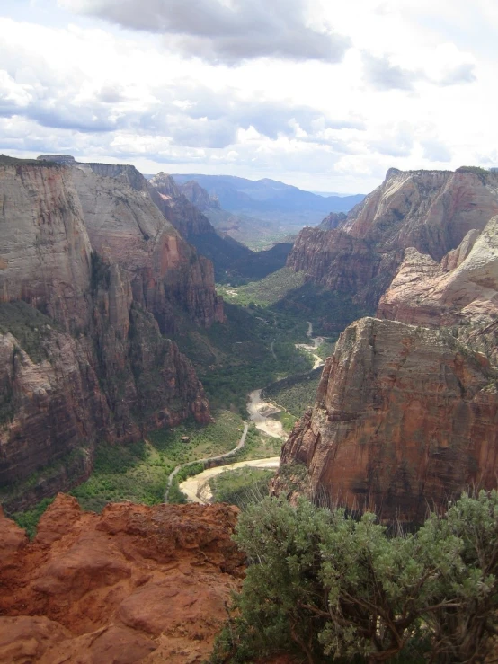 a scenic view of canyons, mountains and a river
