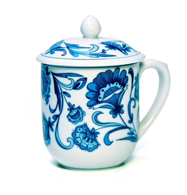 this blue and white mug has floral designs on the side