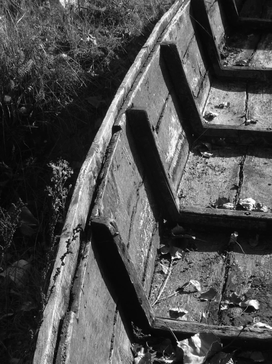 the remains of an old boat in a field