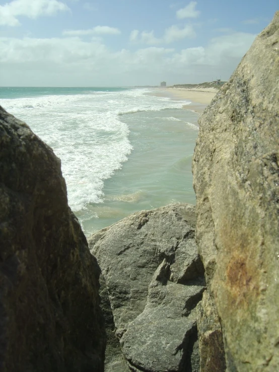 a view from the rocks looking at the ocean