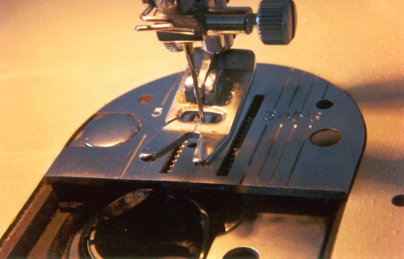 a sewing machine in use on a wooden table