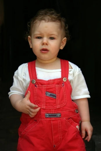 a  in red overalls giving the finger up