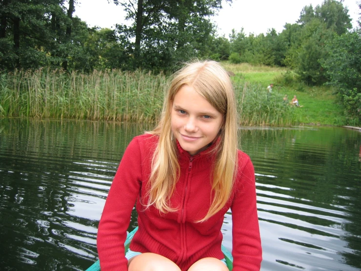 a woman sitting in the middle of a lake