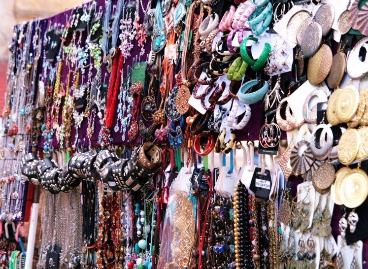 a wall covered in lots of colorful jewelry