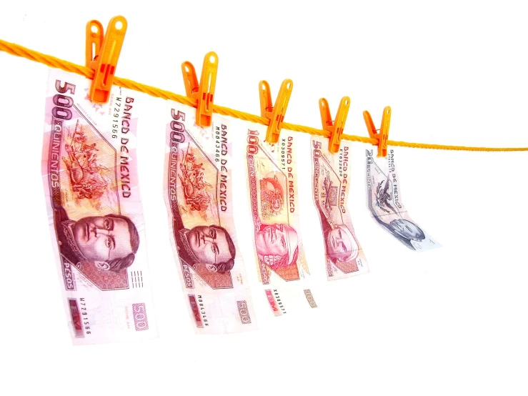 several paper money are hung on a line