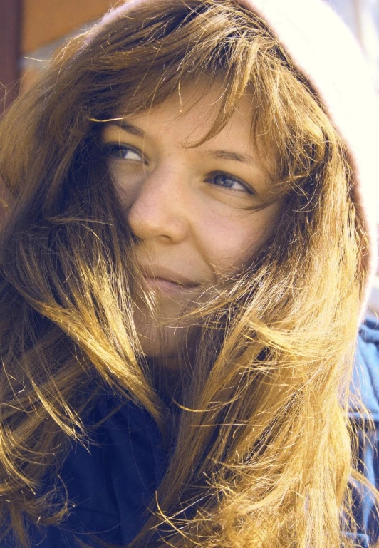 the young woman is wearing blue with a white hat