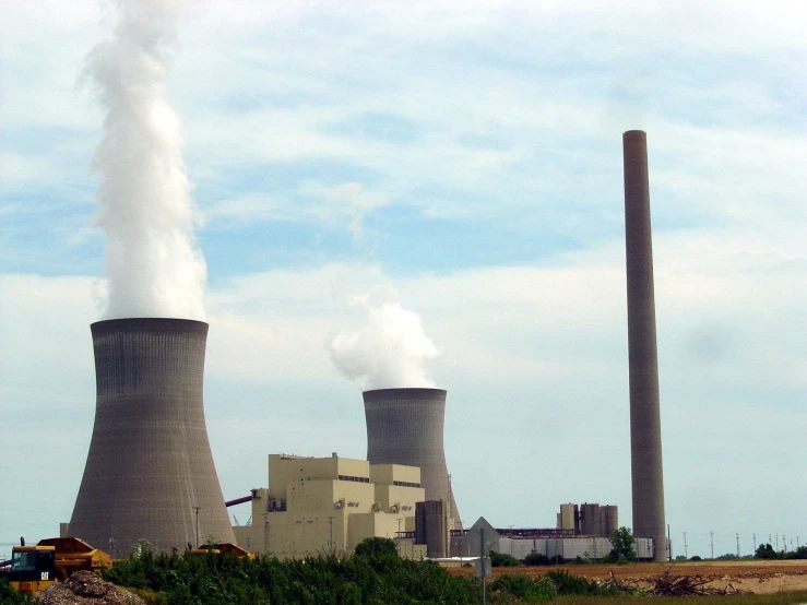 a view of some smoke stacks from a power station