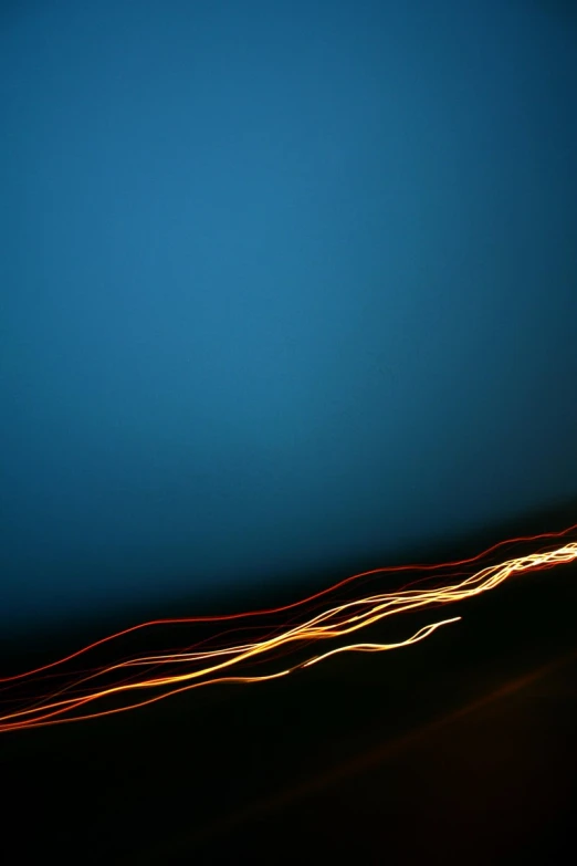 a long exposure of a blue background shows light streaks and shadows