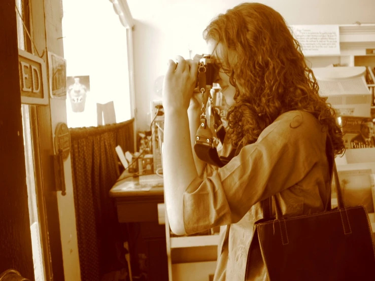 a woman looking through a telescope at soing