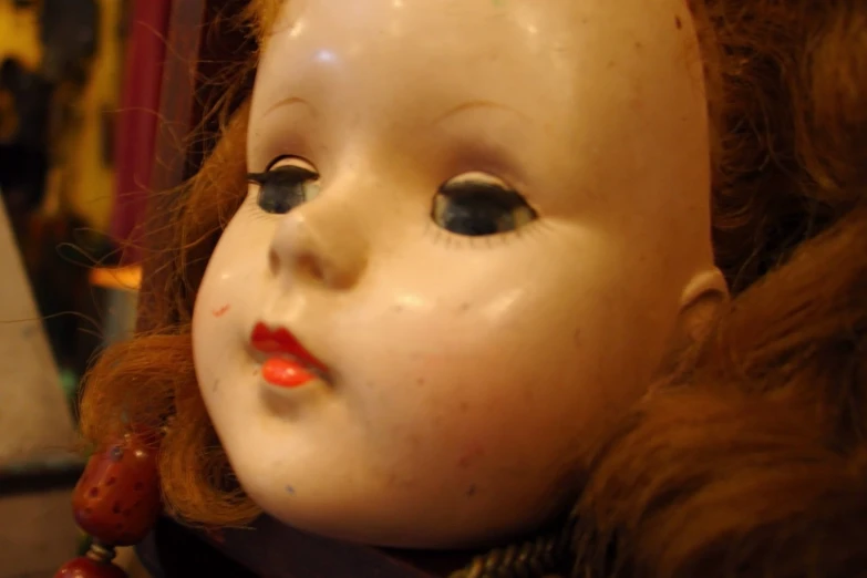 a close up view of a very old doll head