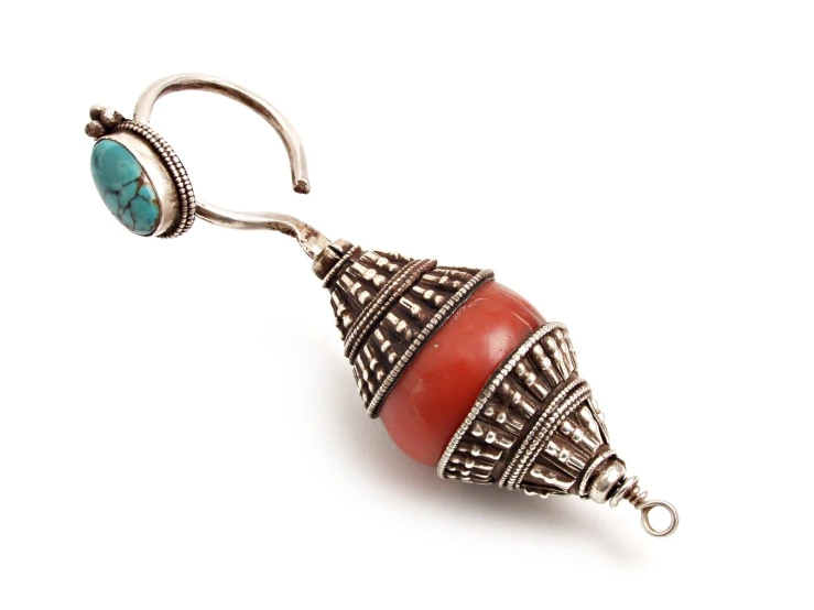 a red stone and silver ear dropper