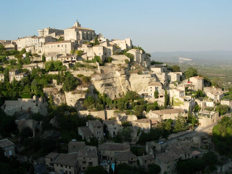 the old buildings in a hilly region are perched on top of each other