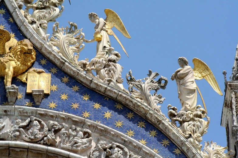 an elaborate sculpture over the front of a building