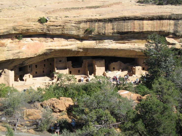 tourists on a tour walk down to cave