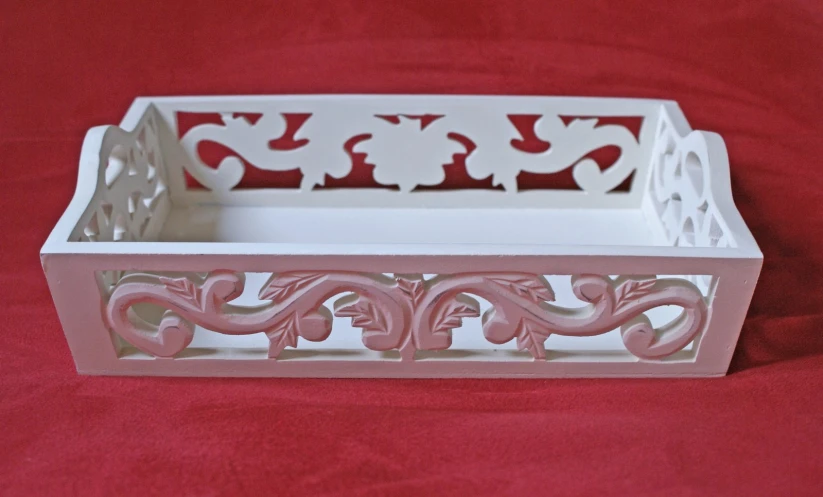 a plastic container with decorative designs is shown on a red background