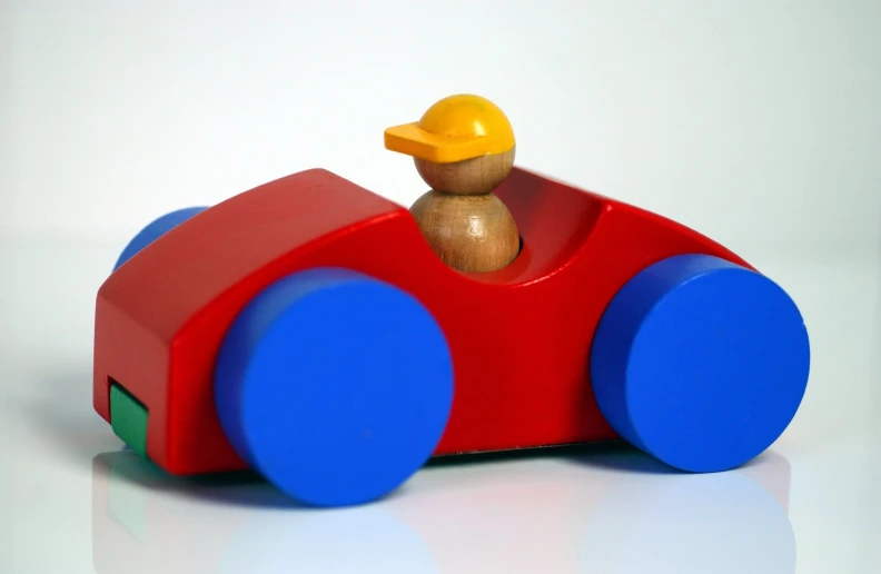 a small wooden toy car with a rubber duck