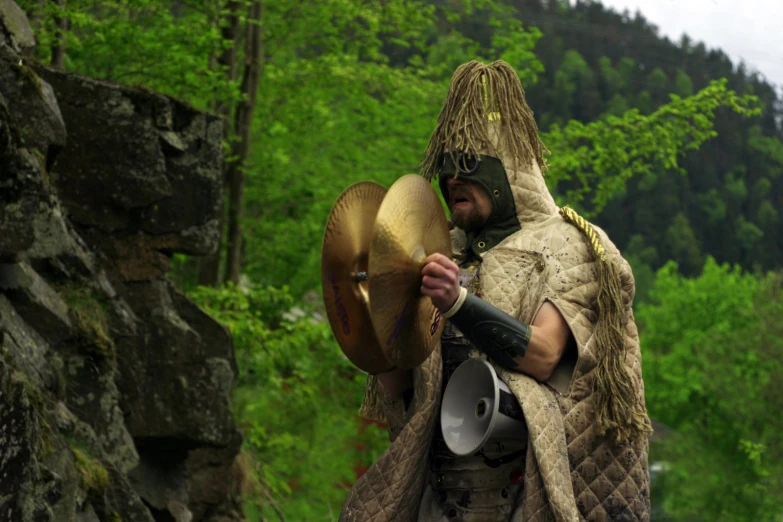 a man in a costume with a hat and a whip