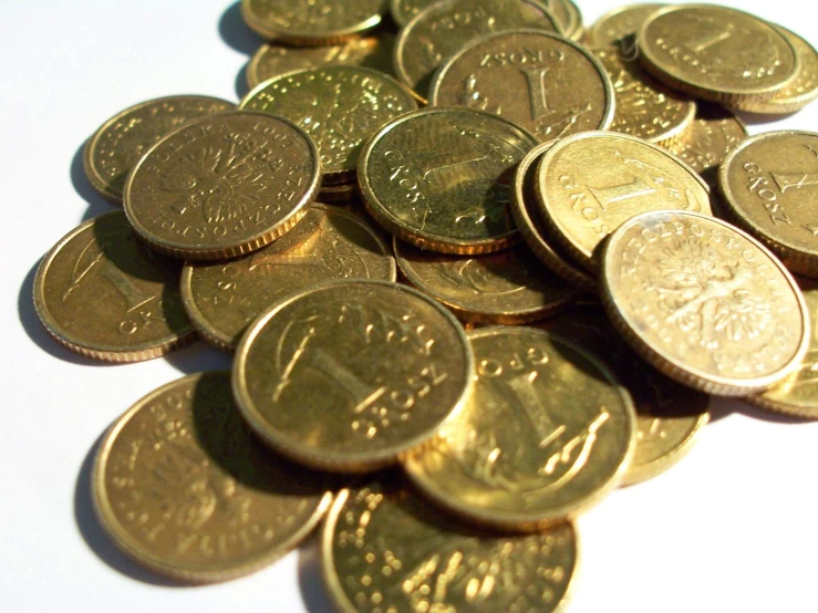 a pile of us coins sitting on top of a table