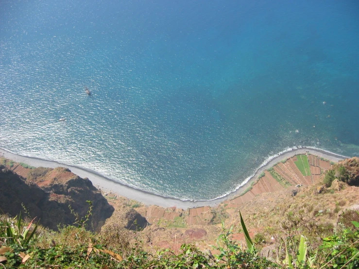 a bird's - eye view of a beach area near a hill