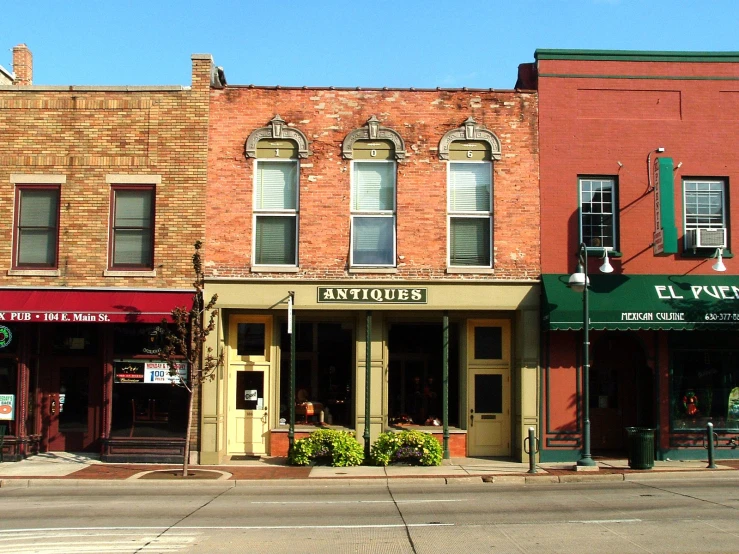 several buildings are lined up with shops in their windows