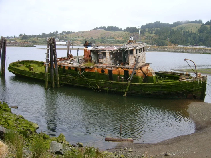 an old rusted ship is in the water